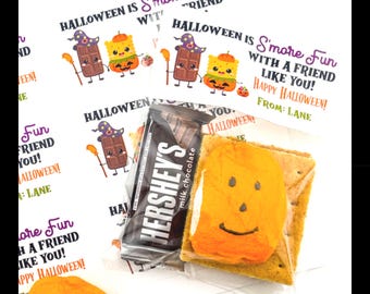 May include: A set of Halloween s'more stickers and clear plastic bags. The stickers feature a cartoon chocolate bar and a graham cracker with a pumpkin face, with the text: Halloween is S'more Fun with a friend like you! Happy Halloween! From: Lane.