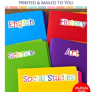 May include: Custom school subject labels featuring colorful text on white stickers applied to blue, red, green, purple, and yellow folders. The labels display the words English, History, Science, Art, and Social Studies in a multi-colored font.