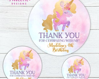 May include: Round stickers with a watercolor background in pink and blue. Each sticker features a gold unicorn with a pink body. Text includes "THANK YOU" and "Madeline's 4th Birthday."