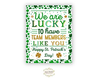 May include: A white printable sign with a green shamrock border. The sign says "We are LUCKY to have TEAM MEMBERS LIKE YOU. Happy St. Patrick's Day!"