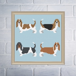 Puede incluir: Cuatro variaciones de color diferentes de un patrón de punto de cruz de un perro basset. Los perros están todos mirando hacia adelante con la lengua fuera. El fondo es de color azul claro.