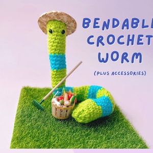 May include: A bendable crochet worm with green and blue stripes, wearing a straw hat. It's on a patch of green grass with a miniature rake and a basket of vegetables. The text "BENDABLE CROCHET WORM (PLUS ACCESSORIES)" is displayed.