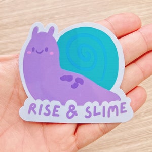 May include: Purple and teal snail sticker with the text "Rise & Slime" on a white background.