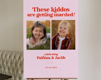 May include: Pink wedding announcement sign with a photo of a young girl and boy. The sign reads "These kiddos are getting married! Celebrating Paloma & Jacob 05.18.20XX"