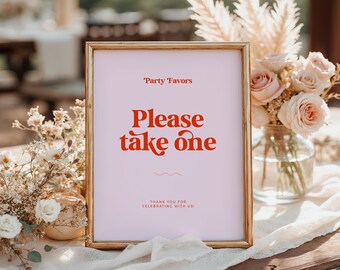 May include: A framed sign with the words "Party Favors" and "Please take one" in red lettering on a pink background. The sign is in a gold frame and is surrounded by flowers and decorative elements.