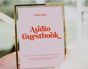 May include: A gold-framed sign with a pink background and the text "Hotline Bling!" in red. The sign says "Audio Guestbook" in red and white text. The sign instructs guests to pick up the phone and leave a message, which will be automatically recorded.
