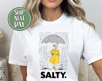 Salty Dutch Girl In Rain With Lavender Umbrella Tshirt, Rain Walking T Shirt, Rainy Day Tee, Positive Mood Shirt, Gift For Rain Lover -FS056