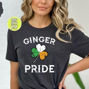 May include: Dark grey heather t-shirt with a shamrock and the text "Ginger Pride".