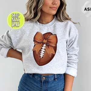 Coquette Football With Bow Sweat And Hoodie, Football Team Shirt, Coquette Bows School Spirit Sweatshirt, Football And Bows - S023