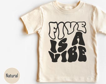 May include: A natural colored t-shirt with short sleeves and a black graphic that says "Five is a Vibe" in a retro font.