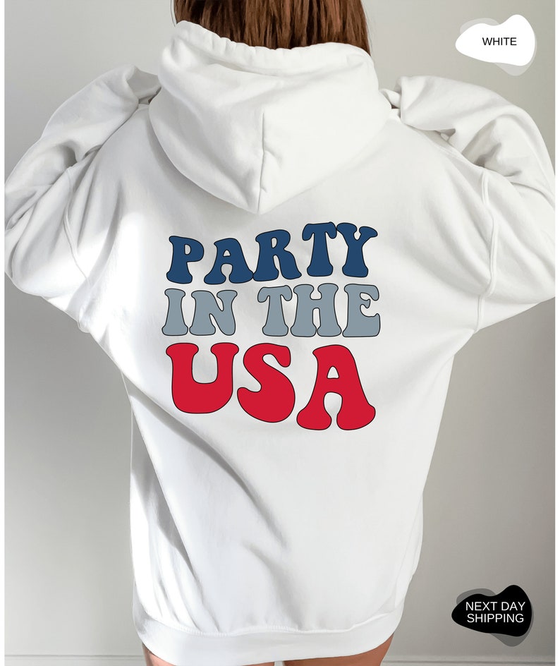 May include: White hooded sweatshirt with the text "PARTY IN THE USA" in red, blue, and gray letters.