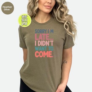May include: A green t-shirt with the text "Sorry I'm Late... I Didn't Want To Come." in colorful letters.
