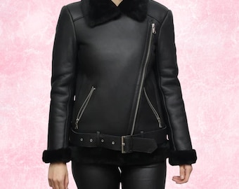 May include: Black leather jacket with a shearling collar and cuffs. The jacket features a diagonal zipper closure, a belted waist, and silver hardware. The jacket is a classic style, suitable for cold weather.
