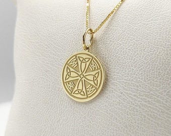 May include: A gold necklace with a round pendant featuring a Celtic knot design.