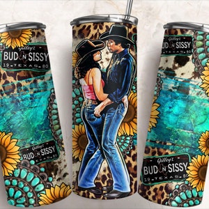 May include: A stainless steel tumbler with a colorful design featuring a couple dancing, sunflowers, turquoise stones, and a leopard print background. The tumbler has the text "Gilley's Bud N Sissy 19.Texas.80" on it.