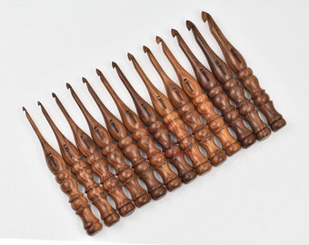 May include: Set of 12 wooden crochet hooks in various sizes, ranging from 3.5mm to 12.00mm. The hooks are made of dark brown wood with a natural finish.