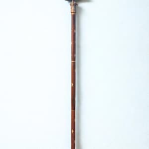 Full profile shot of the elegant Victorian walking stick standing against a wall.length is approximately 90 cm.