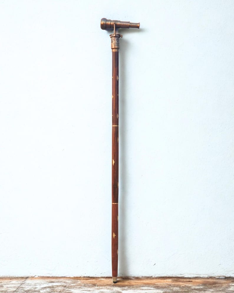 Full profile shot of the elegant Victorian walking stick standing against a wall.length is approximately 90 cm.