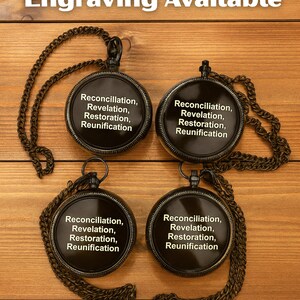 May include: Four round black pocket watches with attached chains. Each watch face features the white text: Reconciliation, Revelation, Restoration, Reunification. The text Engraving Available appears at the top of the image.