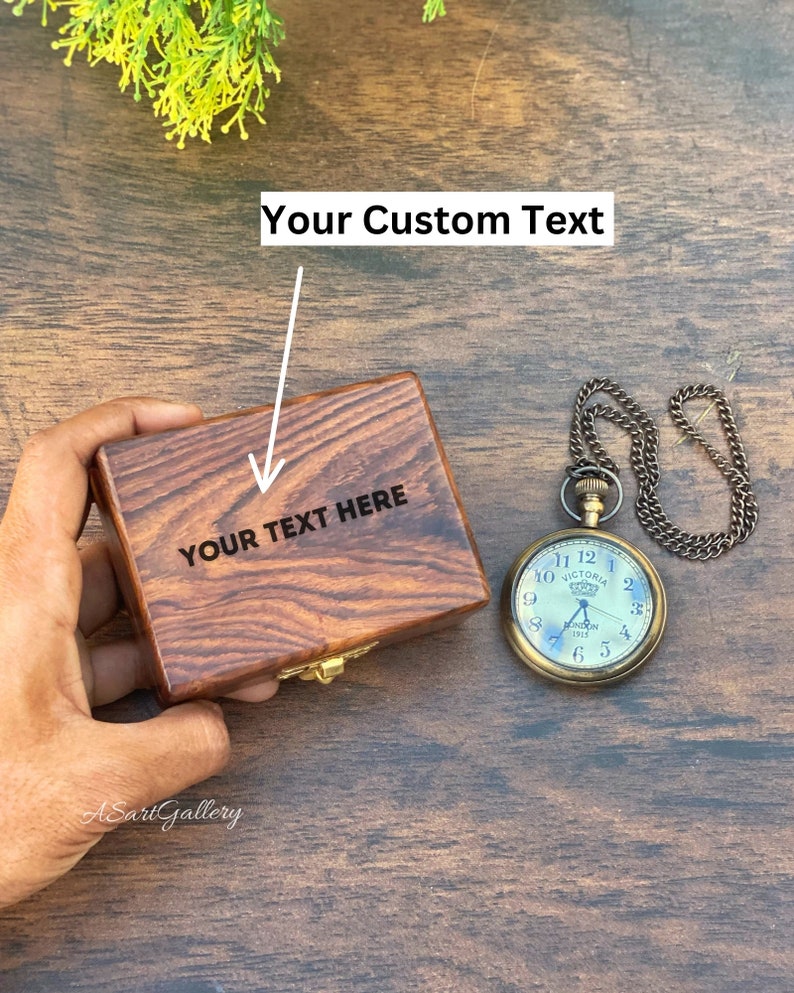 May include: A wooden box with a hinged lid and a brass latch. The box is engraved with the text "YOUR TEXT HERE". A vintage pocket watch with a chain is also pictured.