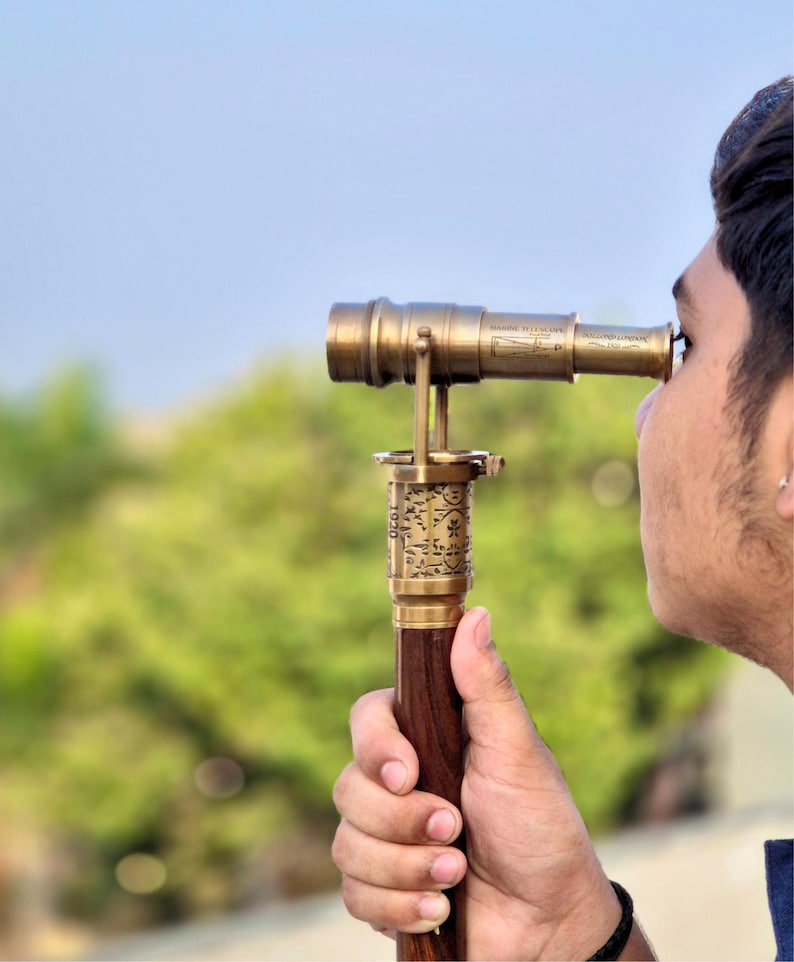 A person using the telescope cane outdoors, demonstrating its functional spyglass feature.