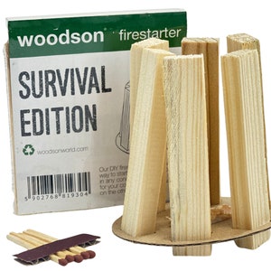 May include: A woodson firestarter survival edition kit with a cardboard base and wooden sticks. The kit is packaged in a box with the text "woodson firestarter" and "SURVIVAL EDITION" printed on it. The box also includes a barcode and the website address "woodsonworld.com".