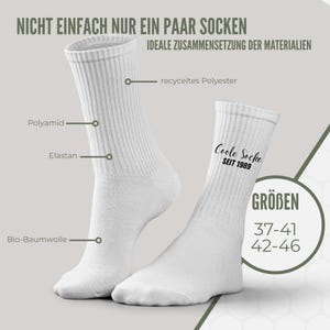 May include: White crew socks with ribbed texture. The text "Coole Socke SEIT 1989" is printed on one sock. The image also shows the sizes 37-41 and 42-46. The socks are made of recycled polyester, polyamide, elastane, and bio-cotton.