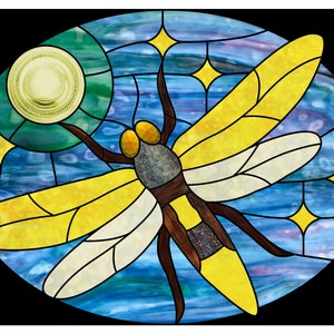May include: A stained glass window depicting a dragonfly with yellow and white wings against a blue and green background with stars.