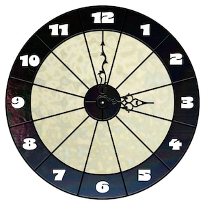 May include: A black clock face with white numbers 1 through 12. The clock face has a white background with a black and white pattern. The clock hands are black.