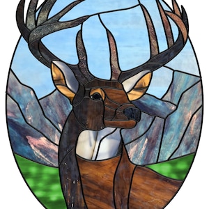 May include: A stained glass window featuring a brown and white deer with large antlers set against a blue sky and mountain backdrop.