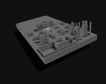 May include: A gray, 3D-rendered model of a rectangular base with various cylindrical and rectangular protrusions. The base has a series of holes and a circular indentation. The model is set against a black background.