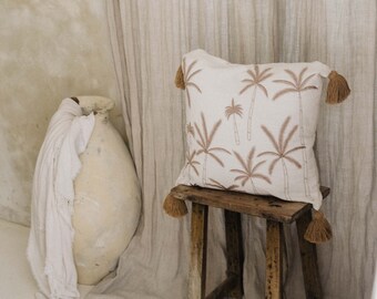 Premium cushion cover in linen with embroidered palm trees and pom poms