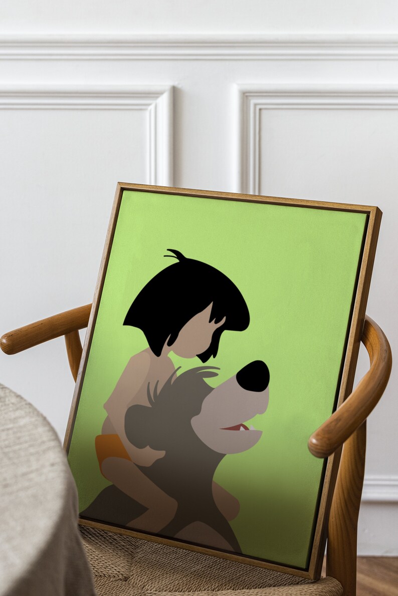 Puede incluir: Una impresi&oacute;n enmarcada de una ilustraci&oacute;n de dibujos animados de Mowgli del Libro de la Selva de Disney montando a Baloo el oso. La ilustraci&oacute;n es de estilo minimalista con un fondo verde.