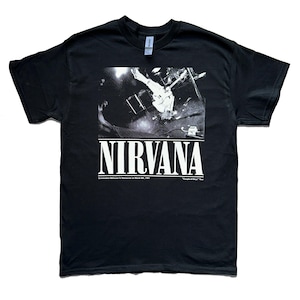 May include: A black short-sleeved t-shirt featuring a white graphic print of a live concert scene. The text NIRVANA is printed in large white letters below the image, with smaller text reading Commodore Ballroom in Vancouver on March 8th, 1991.