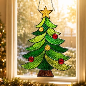 May include: A stained glass Christmas tree ornament featuring vibrant green textured glass, a brown trunk, and a yellow star at the top. The tree is decorated with small, circular red and yellow glass accents and hangs from a black metal chain.