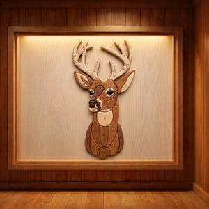 May include: A wooden deer head wall art piece, featuring a detailed design with various shades of brown and tan wood. The antlers are a lighter color, and the head is framed in a wooden box. Numbers are visible on the antlers and head.