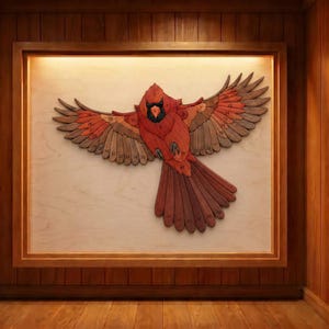 May include: A wooden framed artwork featuring a cardinal bird with outstretched wings. The bird is crafted from various shades of red, brown, and tan wood. The artwork is mounted on a light-colored background and displayed in a wooden frame.