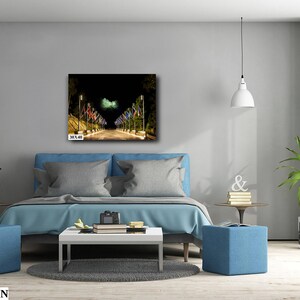 May include: A nighttime cityscape with a street lined with lampposts and flags. The flags are illuminated by the streetlights, creating a warm glow. The image is printed on canvas and measures 30x40 inches.