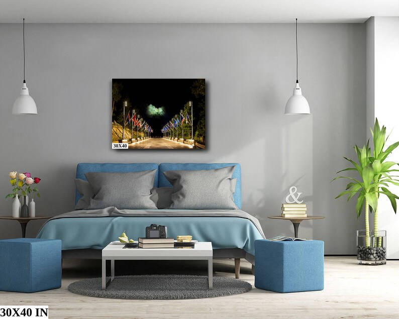 May include: A nighttime cityscape with a street lined with lampposts and flags. The flags are illuminated by the streetlights, creating a warm glow. The image is printed on canvas and measures 30x40 inches.