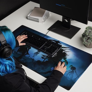 May include: A blue and black gaming mouse pad with a dark fantasy design featuring shadowy figures and a dark blue background.