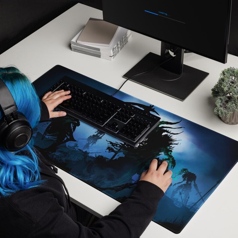 May include: A blue and black gaming mouse pad with a dark fantasy design featuring shadowy figures and a dark blue background.