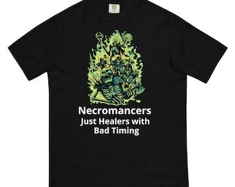 May include: Black t-shirt with a green and black illustration of skeletons and a green flame design. The text "Necromancers Just Healers with Bad Timing" is printed in white below the illustration.