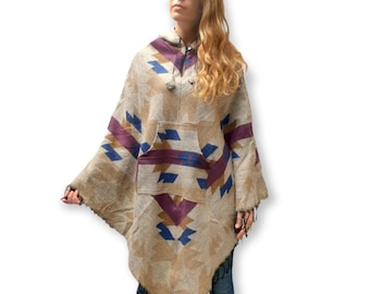 May include: A hooded poncho with a geometric pattern in shades of brown, blue, and purple. The poncho has a large pocket on the front and a drawstring hood.