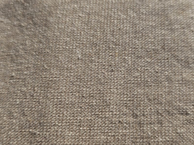 May include: Close-up of a brown woven fabric with a textured surface.