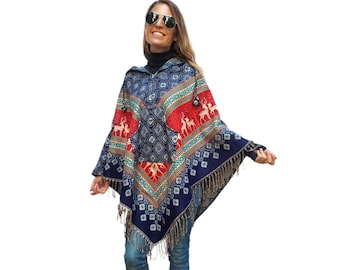 May include: A blue hooded poncho with a red, white, and green geometric pattern and a reindeer design. The poncho has fringe trim.