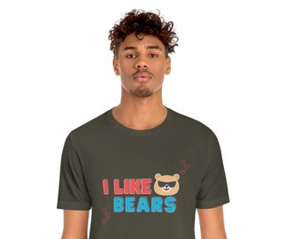 May include: A dark green t-shirt with the text "I LIKE BEARS" in red, blue, and white. A cartoon bear wearing sunglasses is next to the text. There are small red hearts around the text.