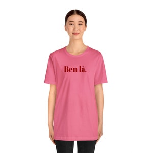 K&ouml;nnte beinhalten: Ein pinkfarbenes T-Shirt mit dem Text "Ben l&agrave;." in Rot auf der Vorderseite.