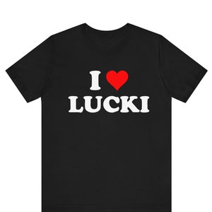 May include: Black t-shirt with the text "I ♥ LUCKI" in white, with a red heart symbol. The shirt is a short-sleeved crew neck.