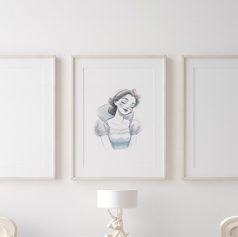 May include: A framed illustration of Snow White, a Disney princess, with a light blue dress and a pink bow in her hair. The illustration is in a white frame against a white wall.