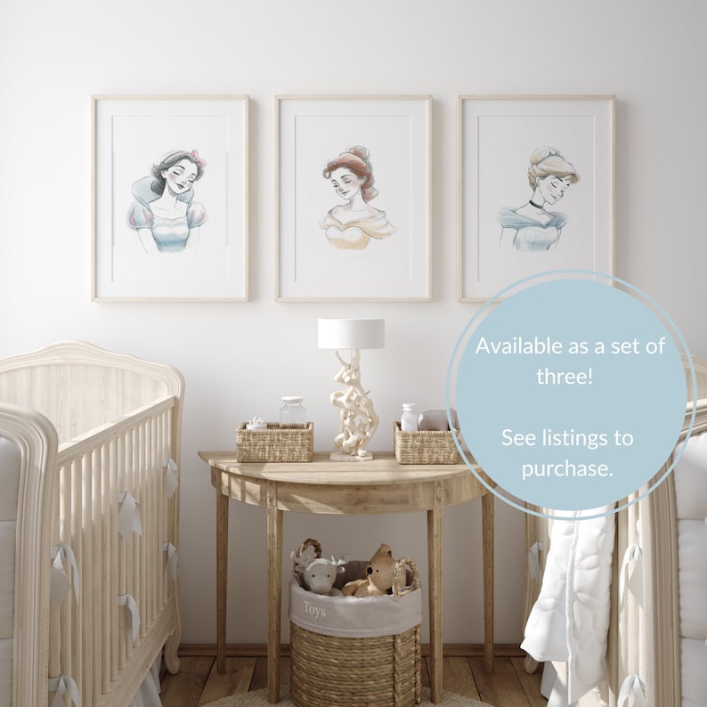 May include: Three framed watercolor illustrations of Disney princesses Snow White, Belle, and Cinderella. The illustrations are in a nursery setting with a crib, a side table, and a lamp.